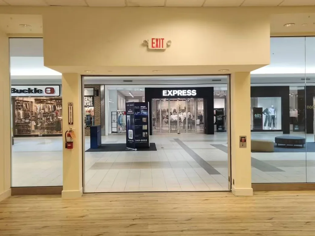 The same unit in warm cream, the ceiling grid, exit sign and shopfront glazing all untouched