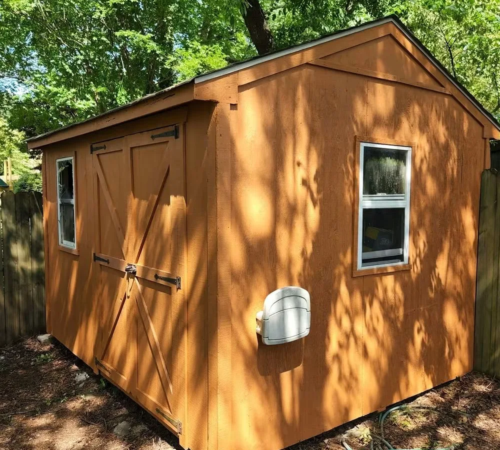 The same shed stained warm cedar, the same doors, the same hardware and the same windows