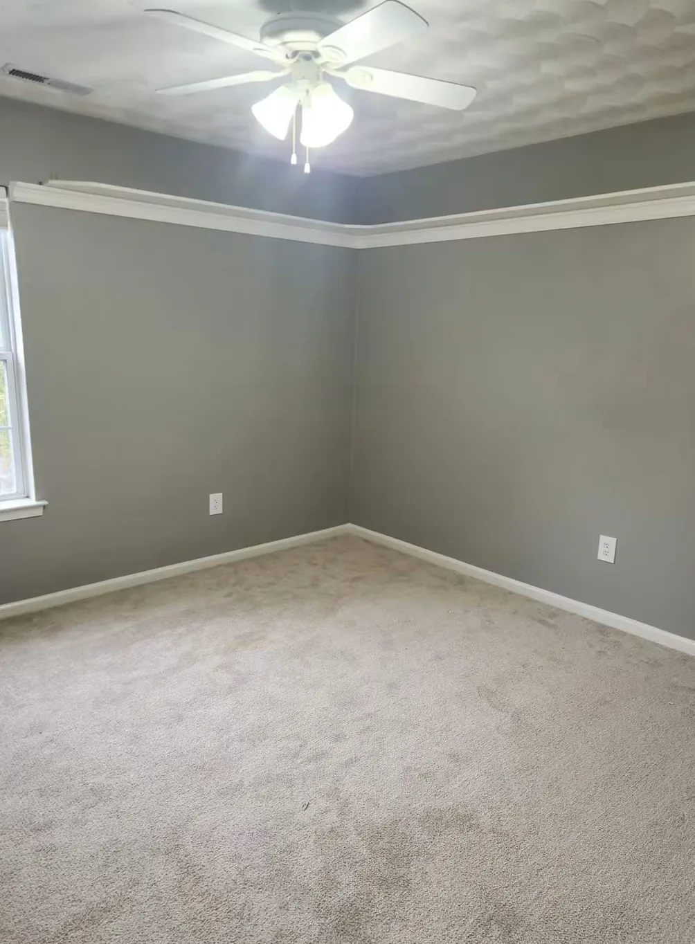 The same bedroom in slate gray-green, crown molding and baseboard still white