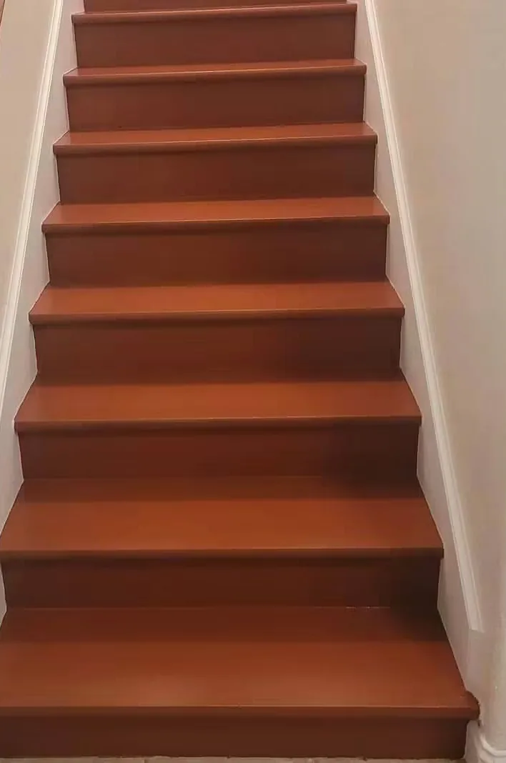 The same staircase with the treads stained and finished against white risers and stringers