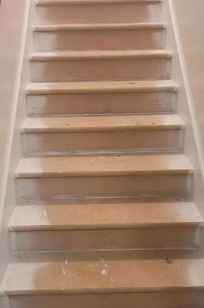 Staircase with the treads sanded back to bare wood and the risers primed white