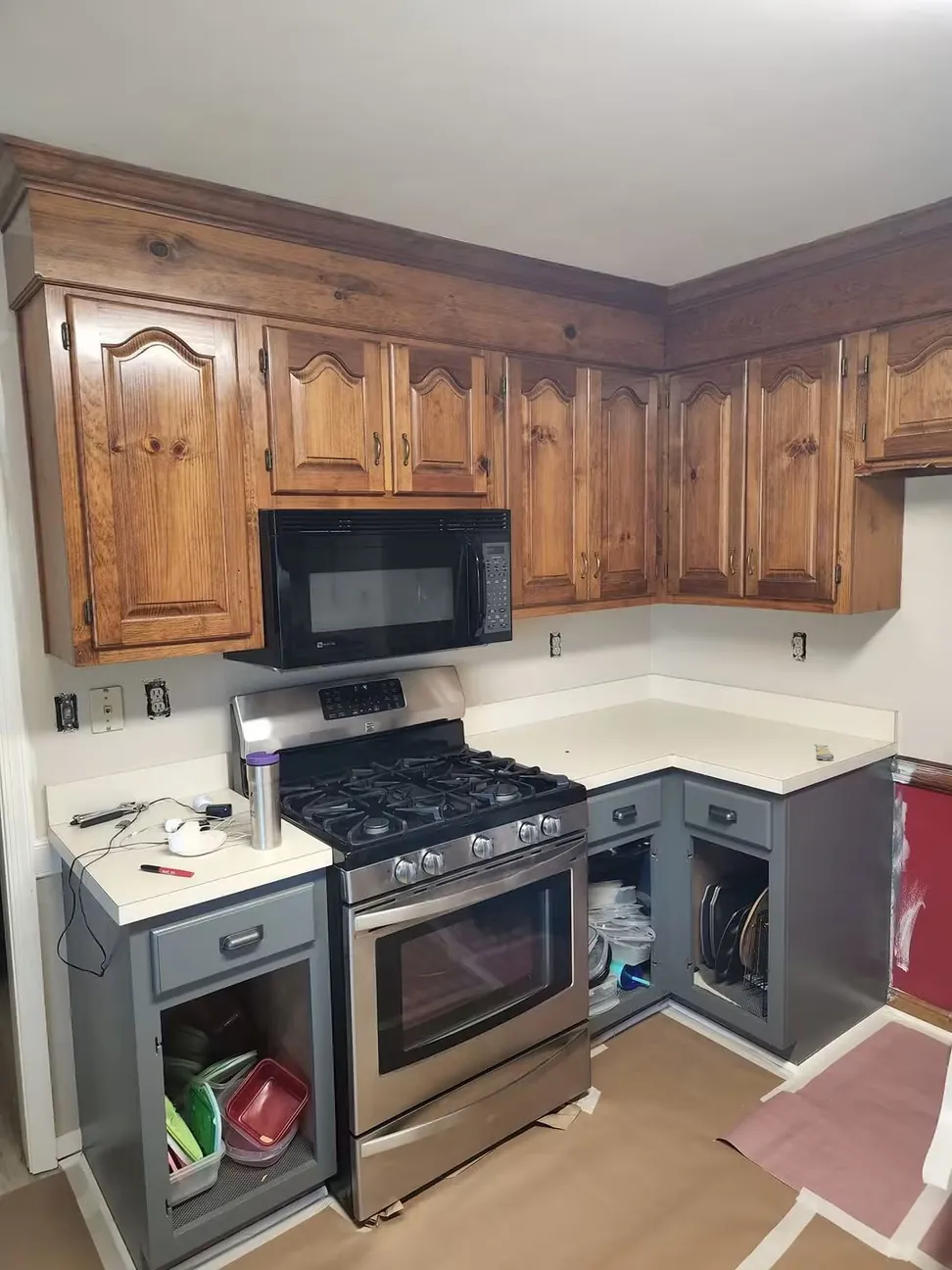 The same kitchen before the wall cabinets were done, dark oak cathedral doors above the range