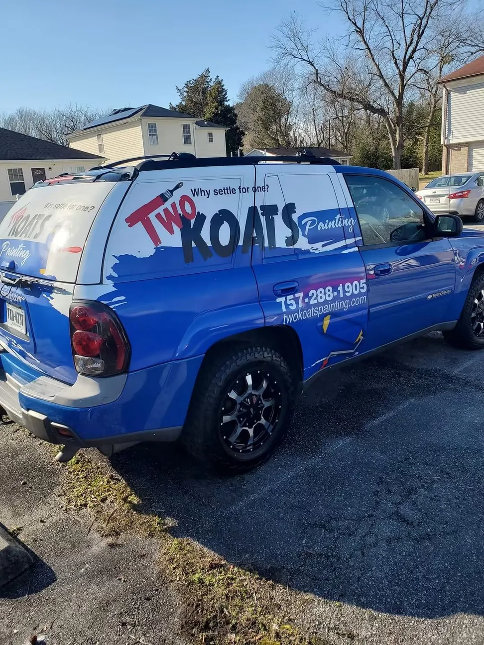 The Two Koats Painting company vehicle, liveried with the logo, phone number and web address