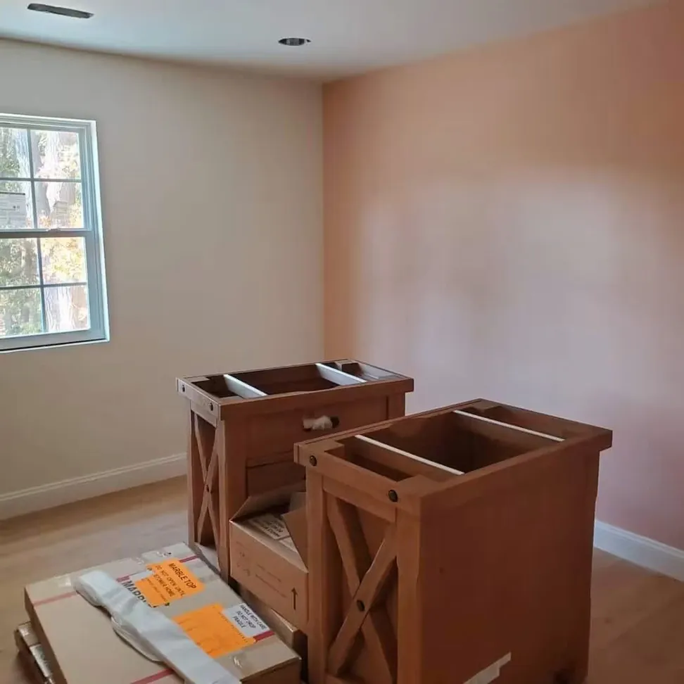 Bedroom in a soft blush, cut in around the window and left ready for the cabinets going in