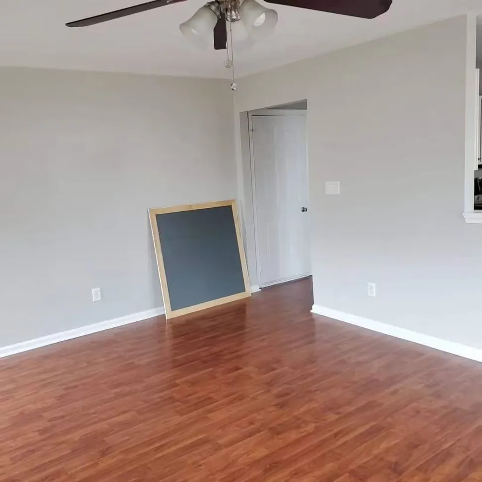 Living room finished, the patched wall now flat and even under two coats