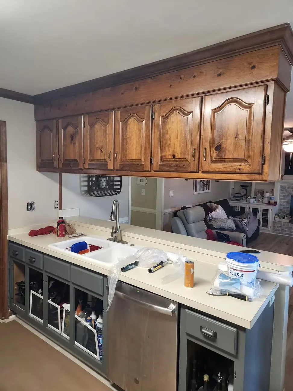 Cabinet doors off and the boxes masked, the countertop and sink sheeted before priming begins