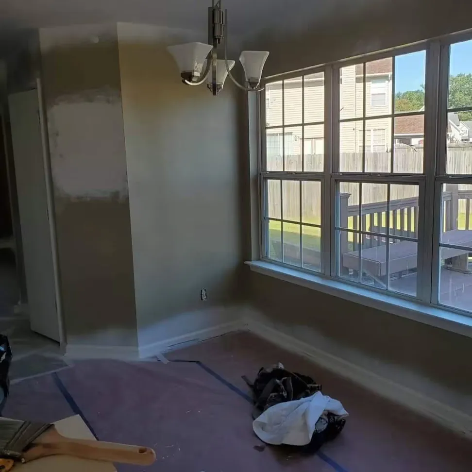 Cutting in a dining room, the first coat on and the floor still under paper and tape